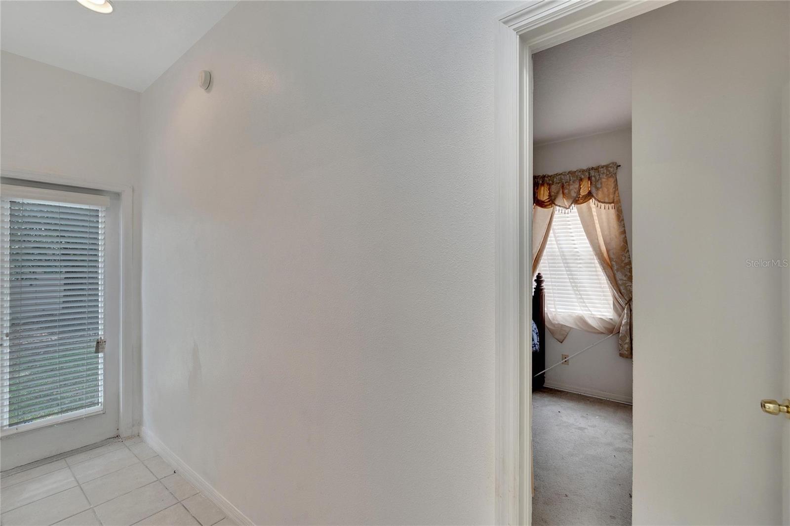 Hallway for Secondary Bedrooms with private glass door into the backyard