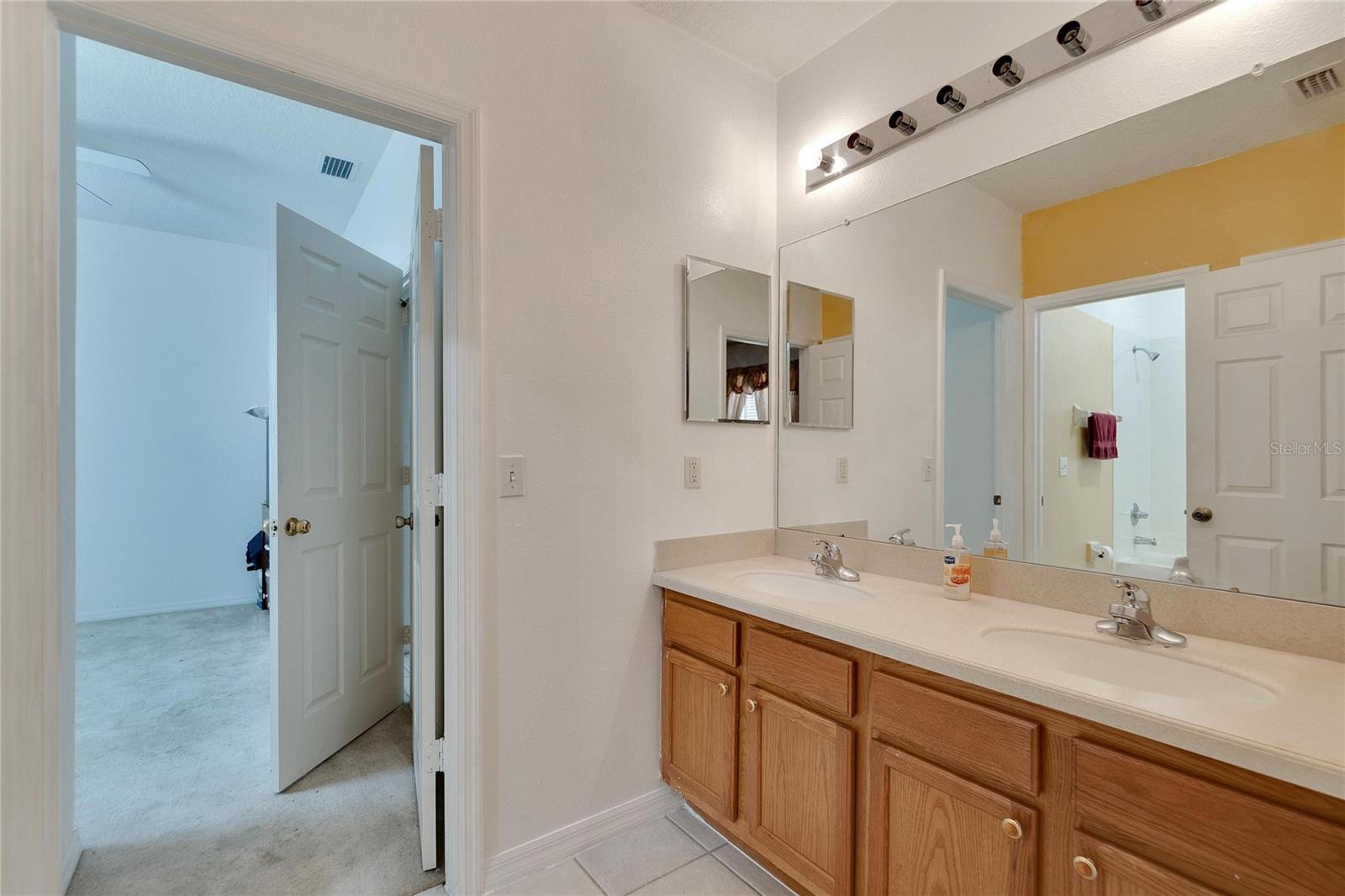 Jack and Jill Bathroom (2) with Double Vanity shared between (Secondary Bedrooms (2 & 3)