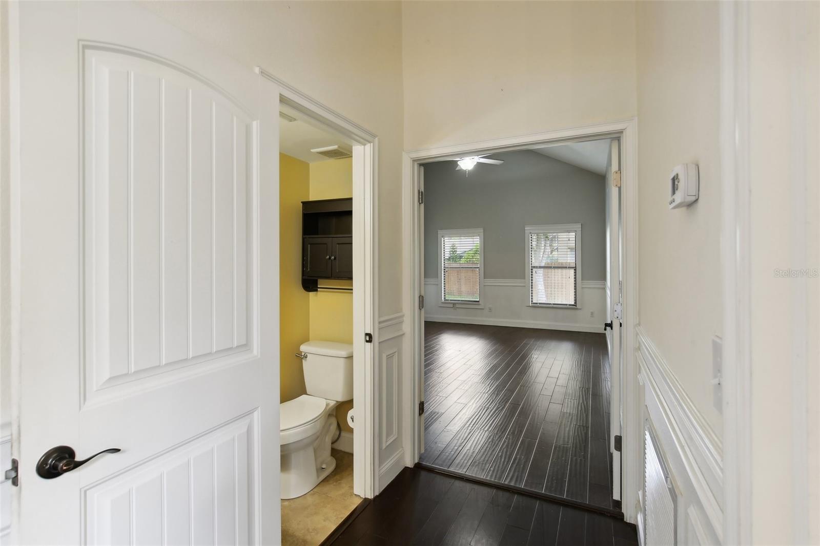 HALF BATH AND ENTRANCE TO MASTER BEDROOM DOWNSTAIRS