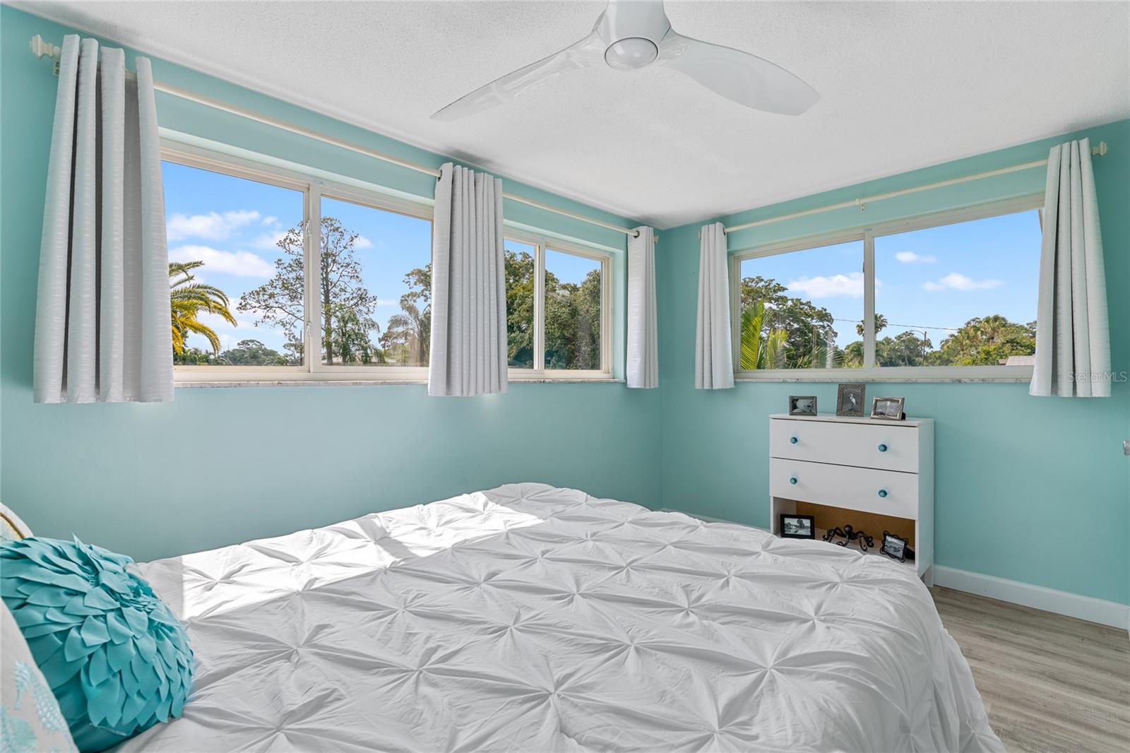 Bedroom 2 also has large windows and luxury vinyl flooring