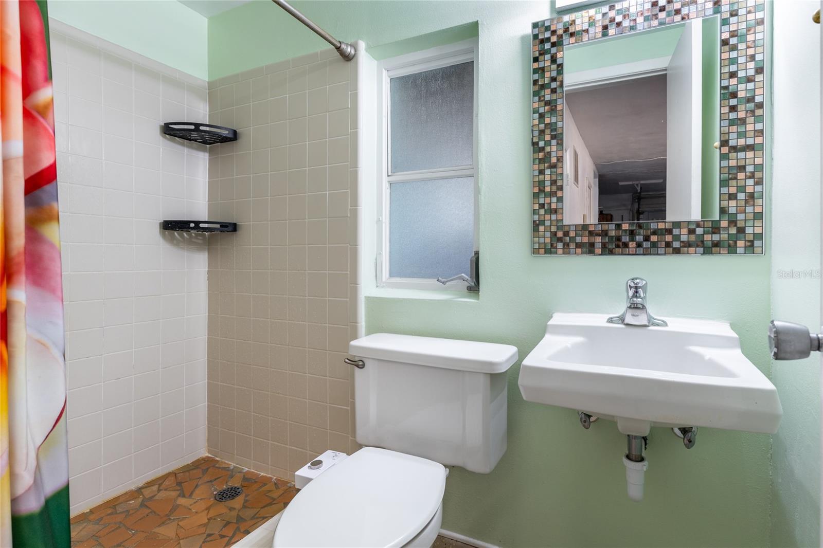 This full bathroom is located in the garage, convenient for rinsing off after a day at the beach or garden/yard work etc.