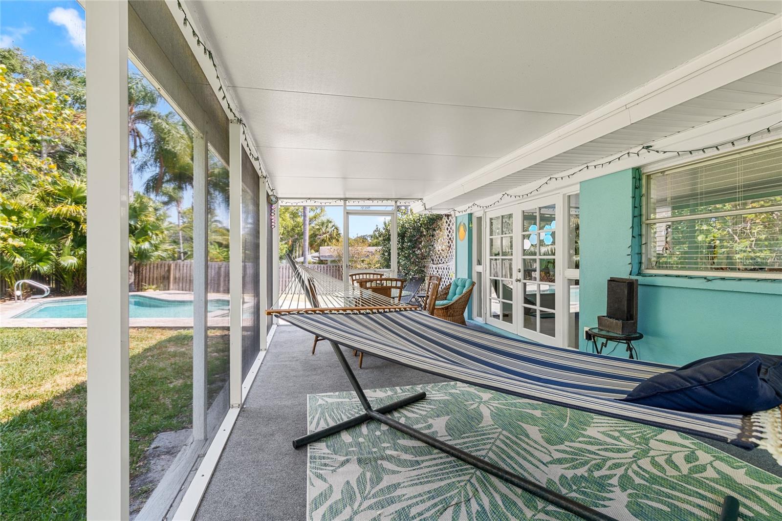 The screened lanai is not only large enough for a hammock but also additional space for a table and chairs.