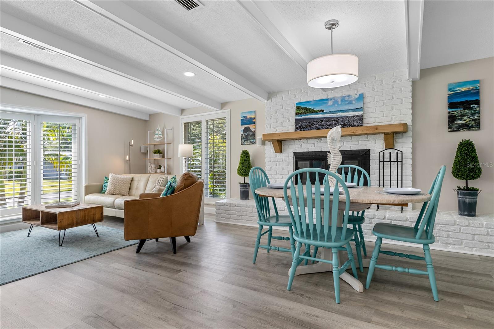 The Dining Room flows seamlessly into the Great Room and has a perfect view of the Wood Burning Fireplace.