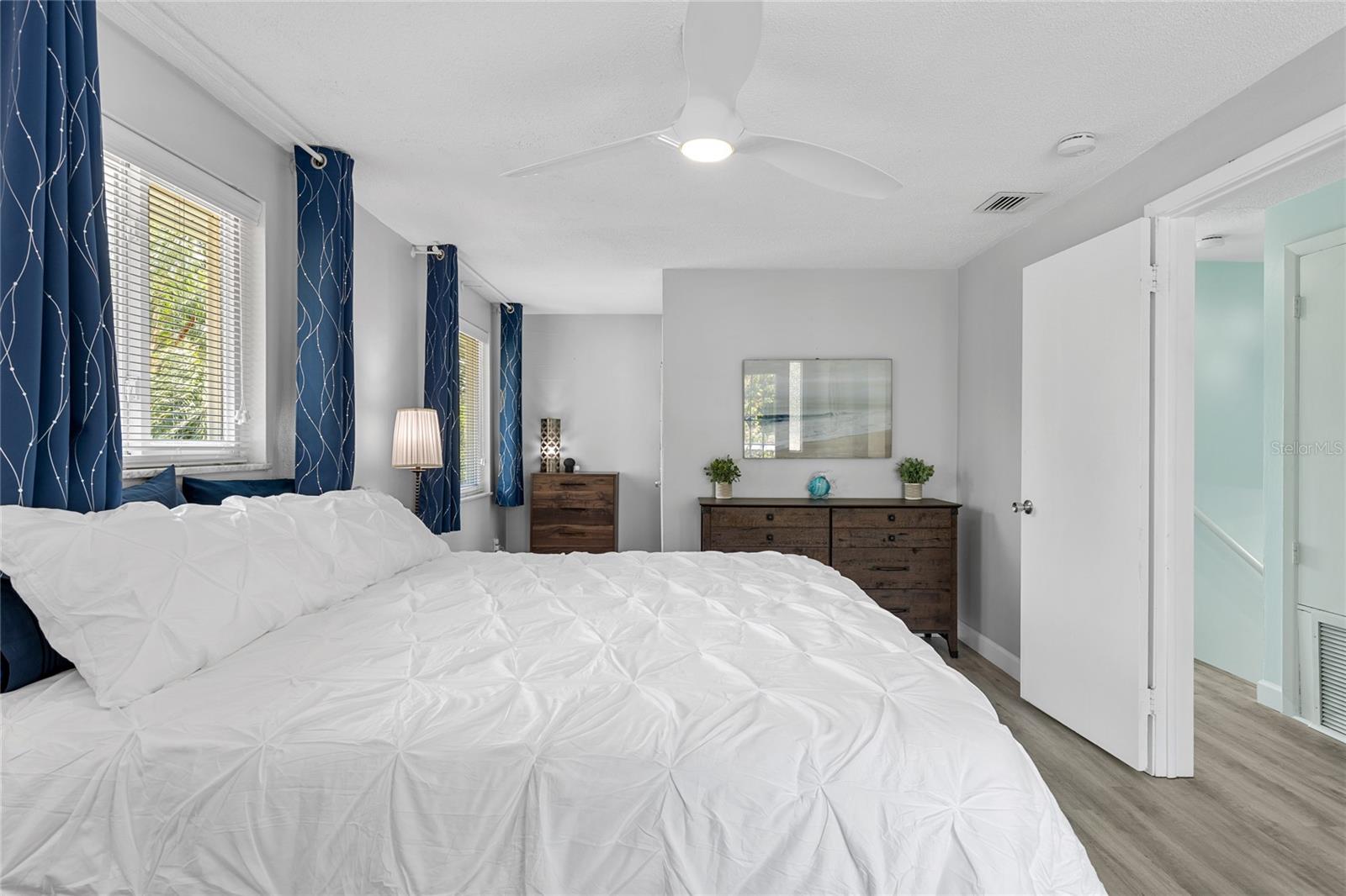 The Primary bedroom is ample sized with large windows and beautiful Luxury Vinyl floors