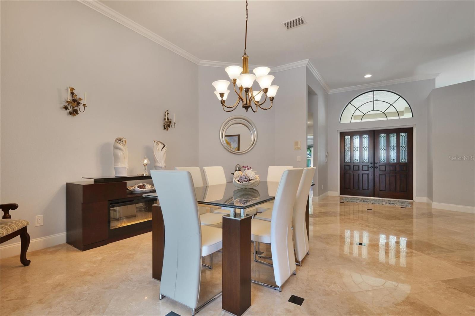 Formal dining room is elegant. High ceilings crown molding sliding doors to let the sunshine inside.