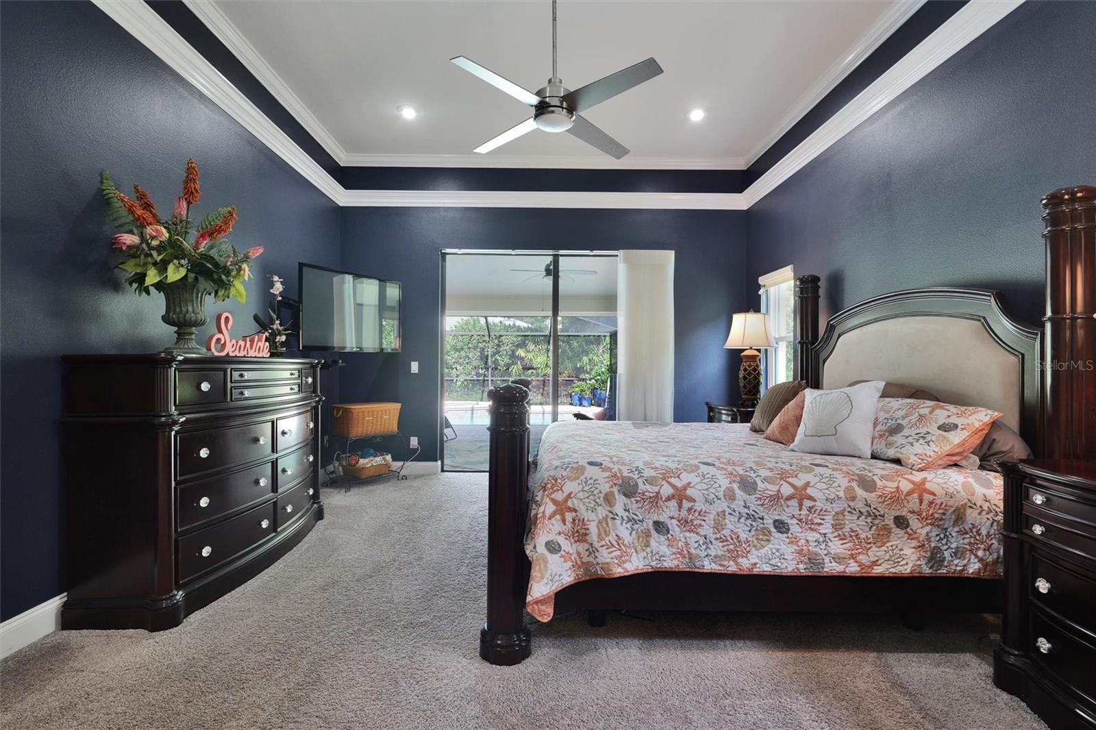 Master bedroom has sliding door leading to the pool.