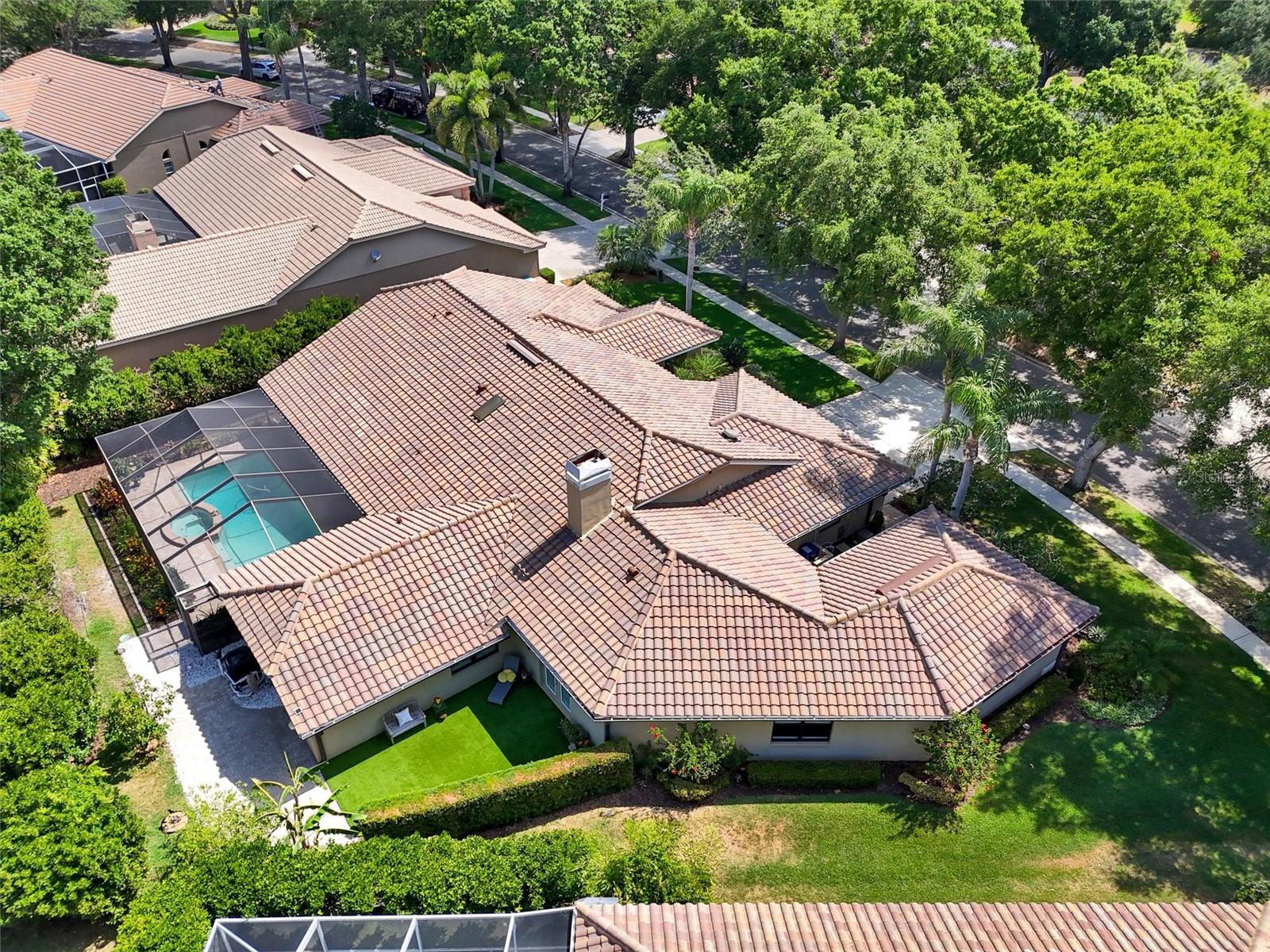 Arial shows a court yard with artificial grass, pool area.