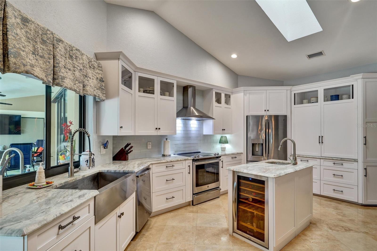 Gorgeous Kitchen, Quartz countertops, Coffee nook and appliance garage. Stainless appliances, wine fridge, Custom Cabinets with pot and pan drawers.