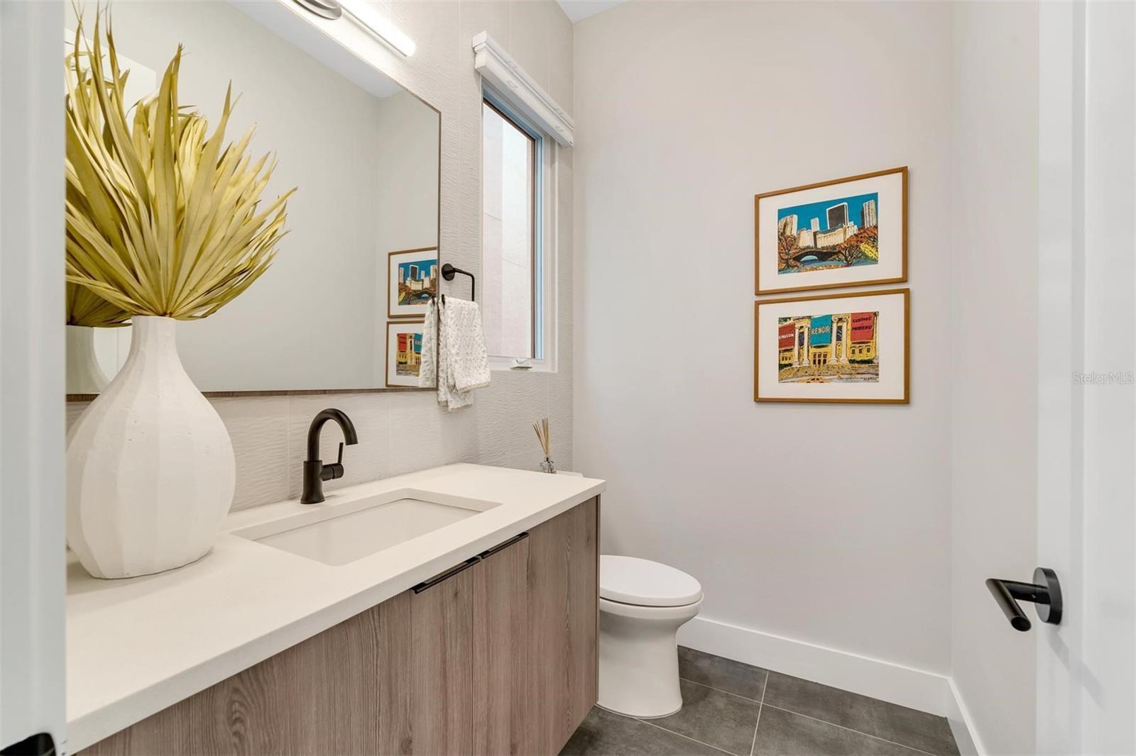 Second floor half bathroom featuring quartz countertops.