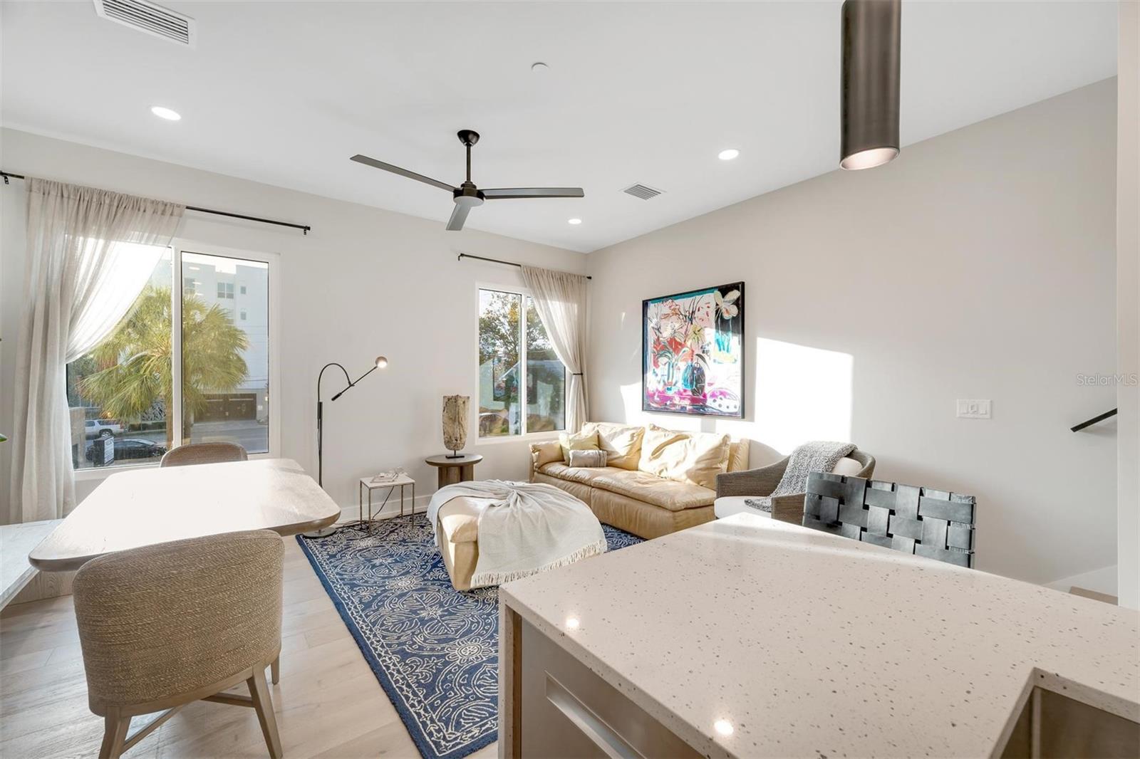 Dining and living rooms bathed in natural light.