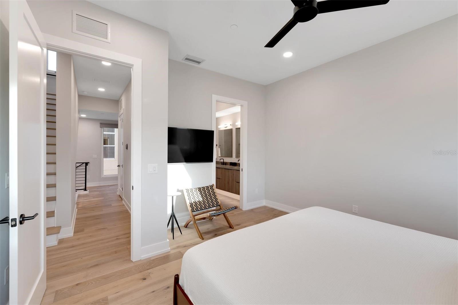 Primary suite with a view into the expansive bathroom.