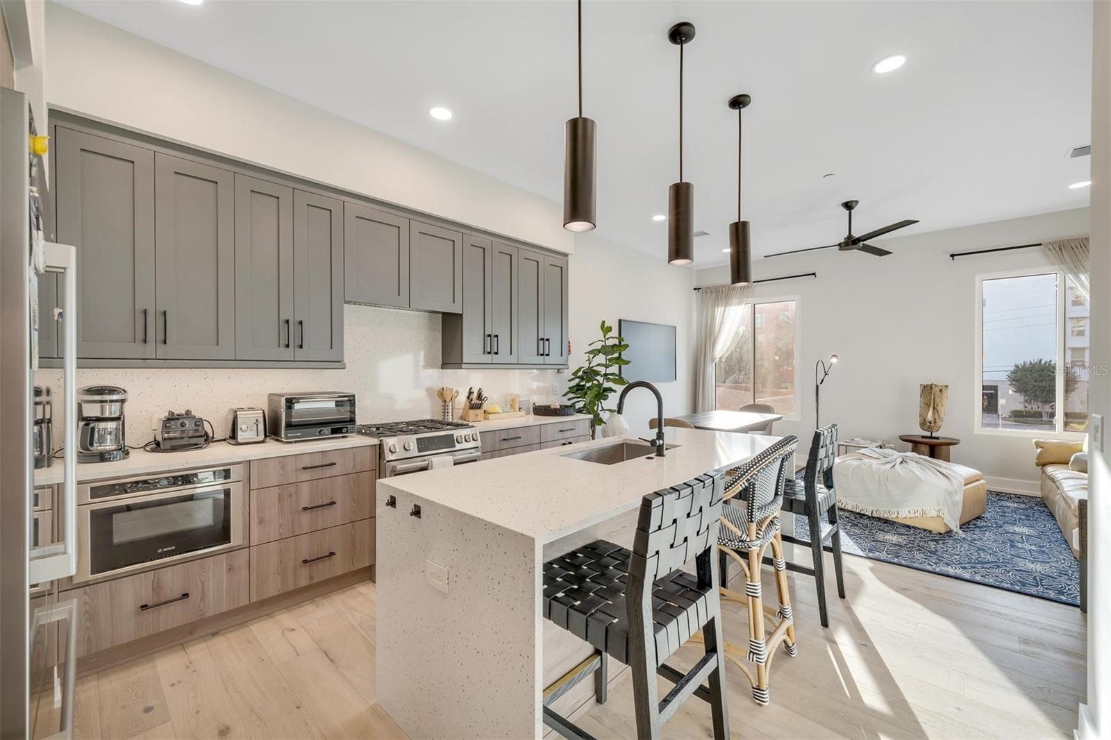 The kitchen island showcases a spacious farmhouse sink.