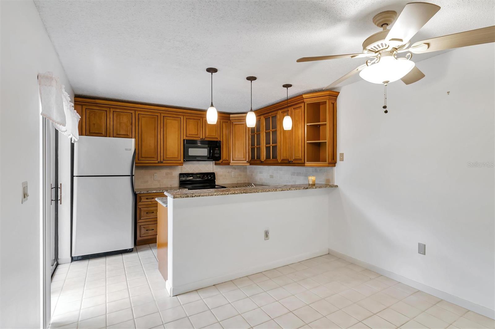 Kitchen with dining space and granite countertops, new cabinets and appliances
