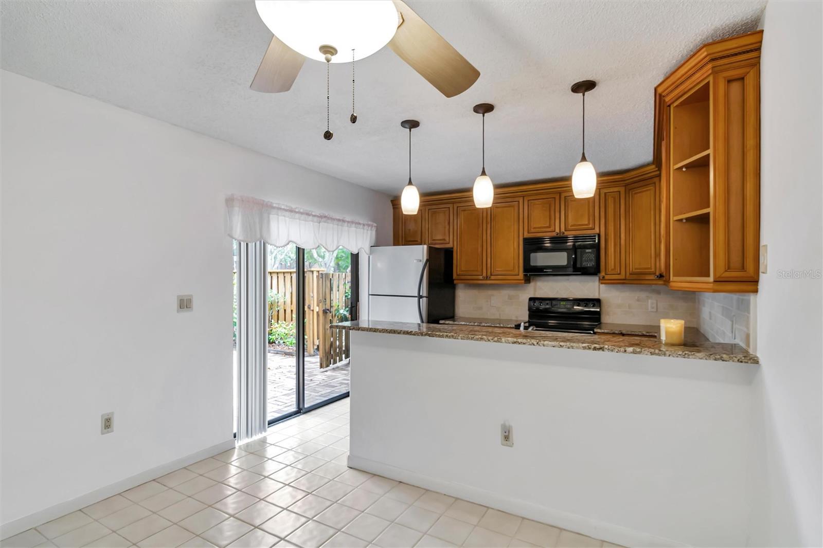 Updated kitchen with sliding glass doors to lead to patio. Perfect for BBQing and easy access to patio from kitchen