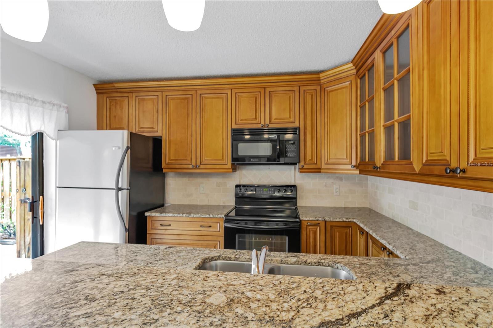 Granite countertops, newer extended cabinets and breakfast bar