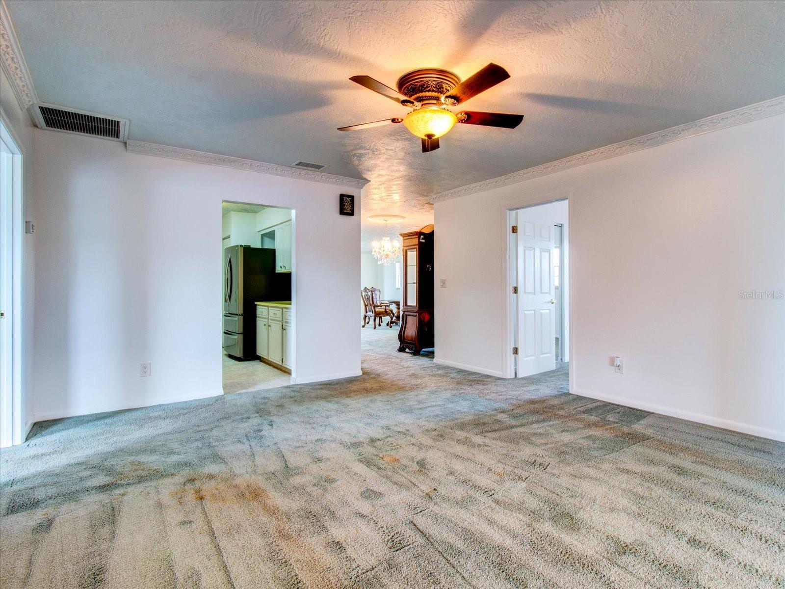 TV Room Looking toward Kitchen Entry on the left, and Dinette area thru to the Front Entry Living Room, and Master Bedroom entry on the right.