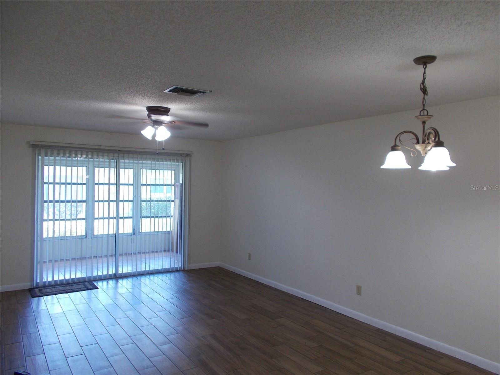 The Great Room with the lanai in the background separated by a sliding door.