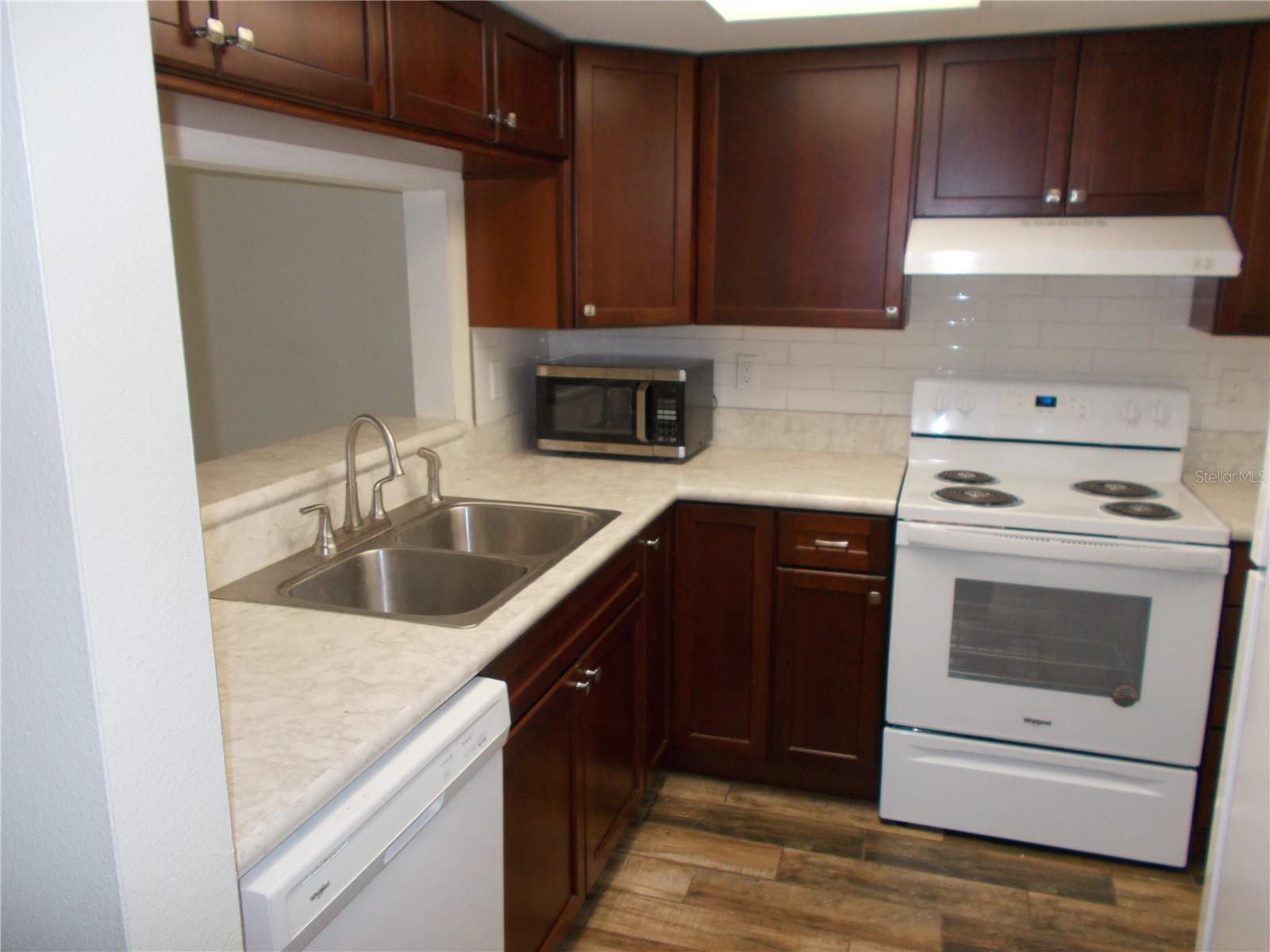 The kitchen from the entrance opening in the hallway.