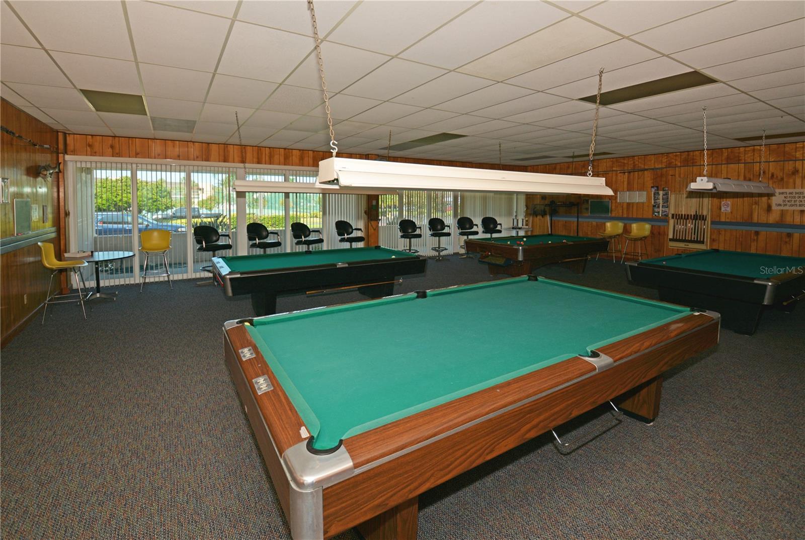 Billiards room with several pool tables.