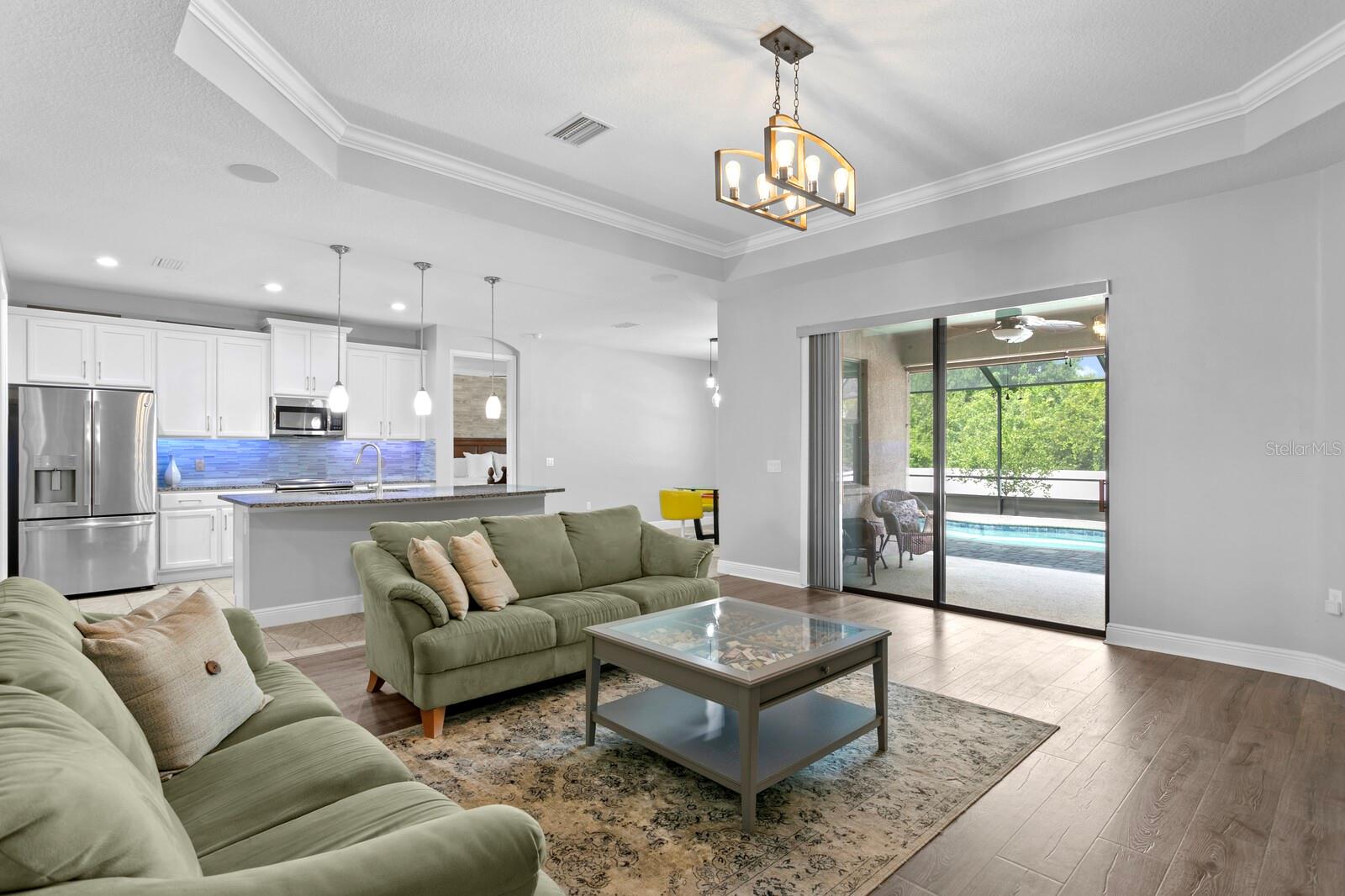 Sliding glass doors lead out to the private pool