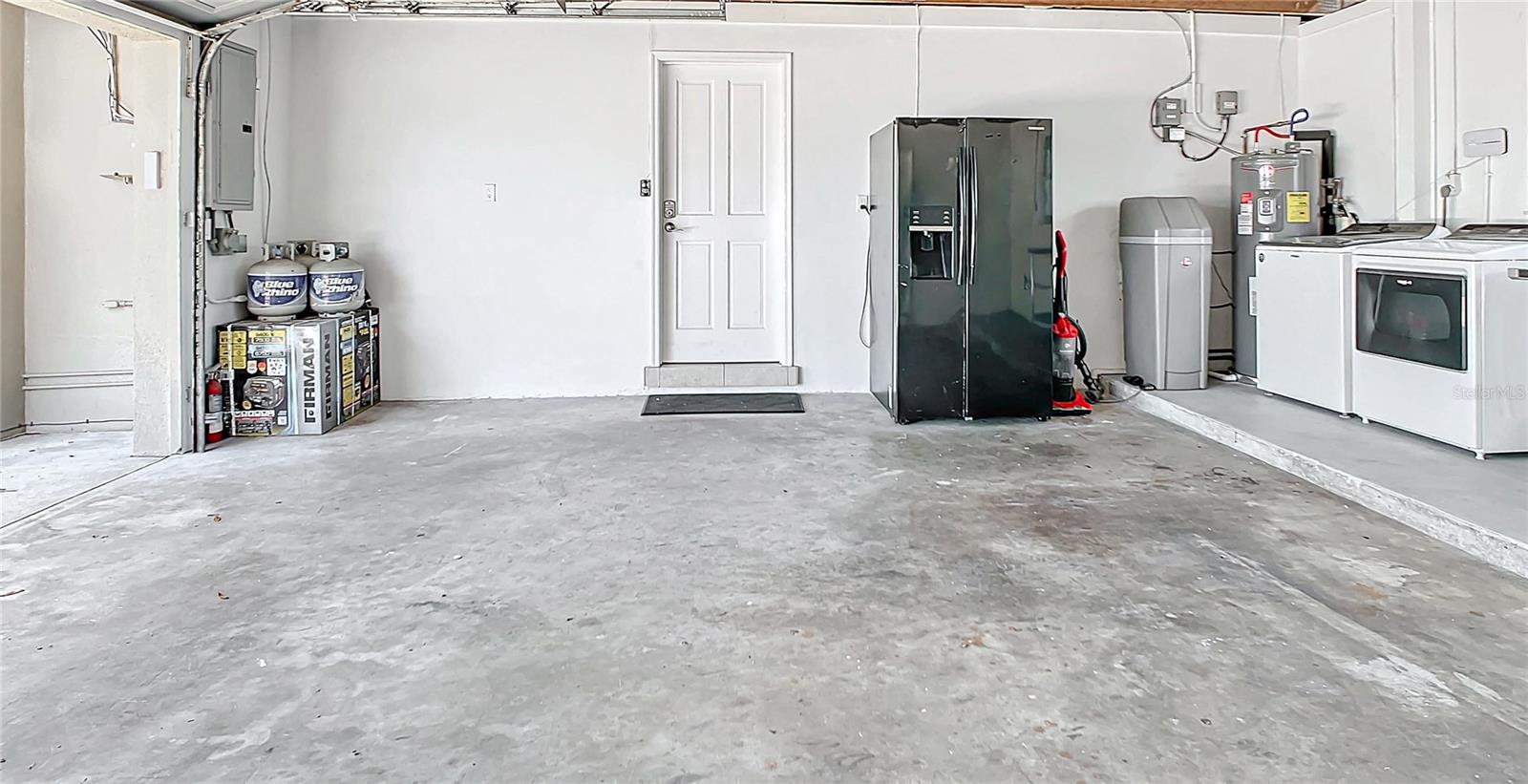 2 car garage with propane generator, 2nd fridge, wifi water heater and water softner