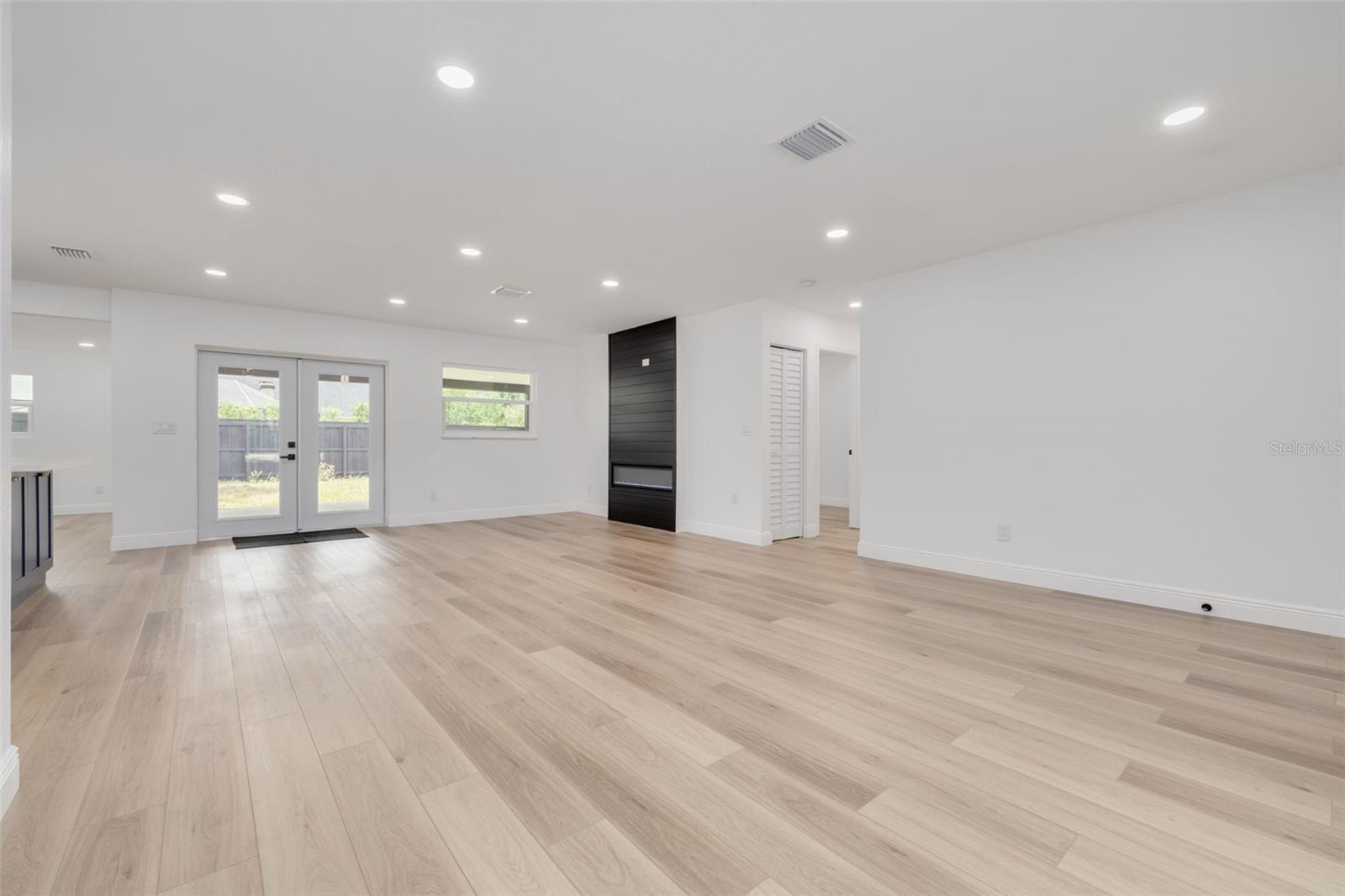 Living room, kitchen on lift, French doors to patio