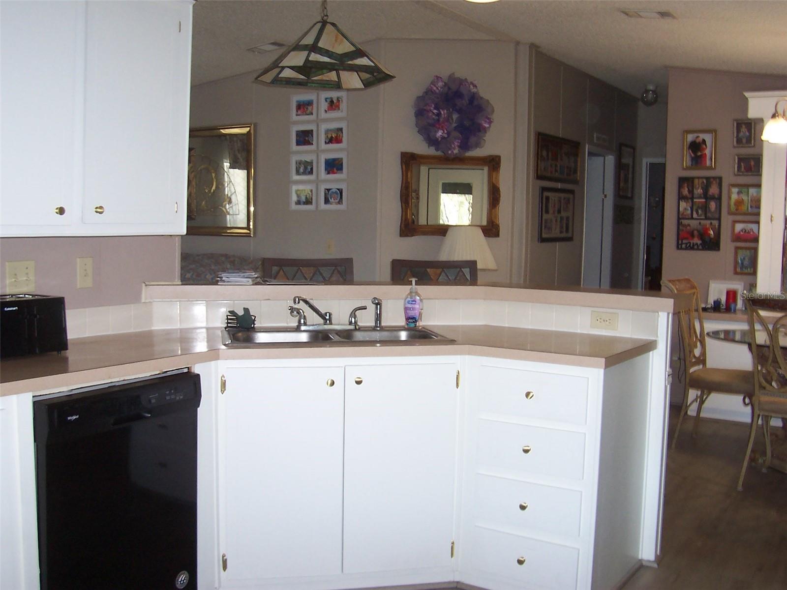 Kitchen features dishwasher, range and refrigerator.  Convenient assess to Formal Dining Room.