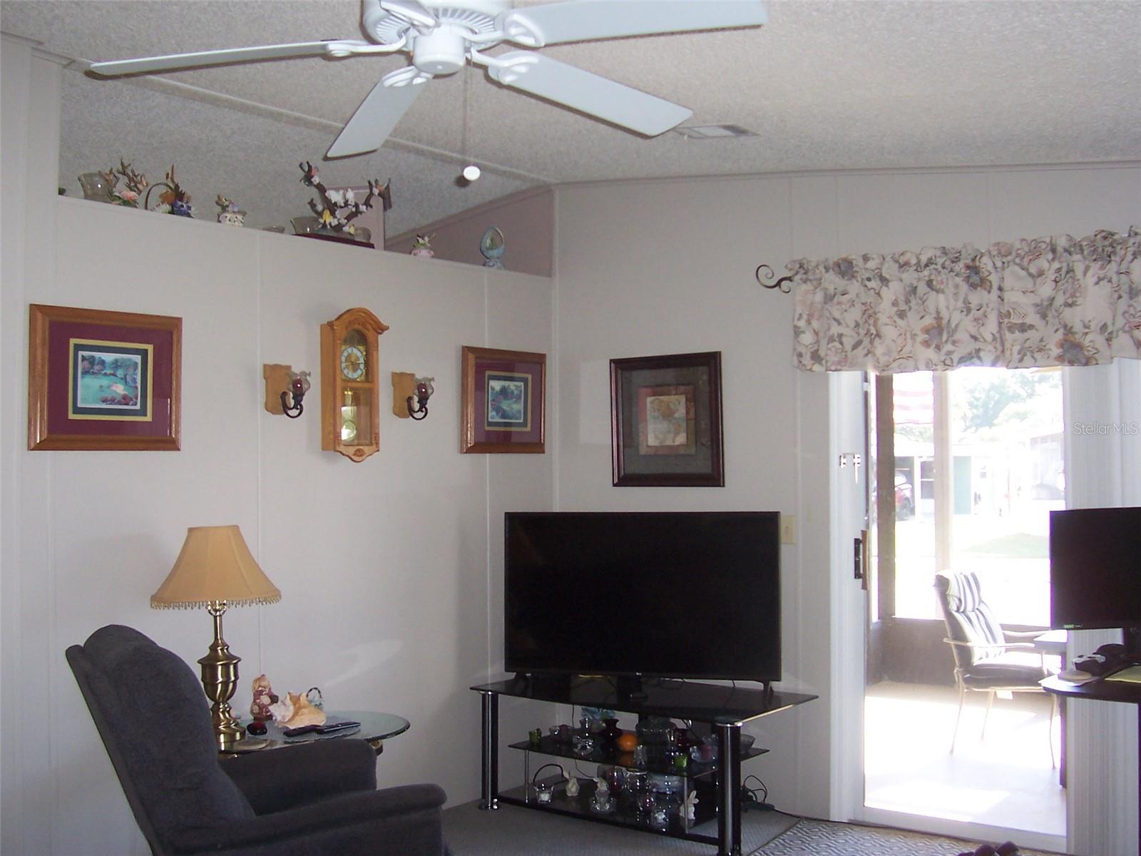 Notice Sliding glass door that goes to the screen room.  It allows so much natural light into the home.  Notice the pretty decorator niche between Living Room and Kitchen.