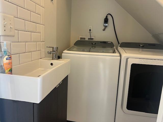 Laundry room with sink, washer and dryer is included