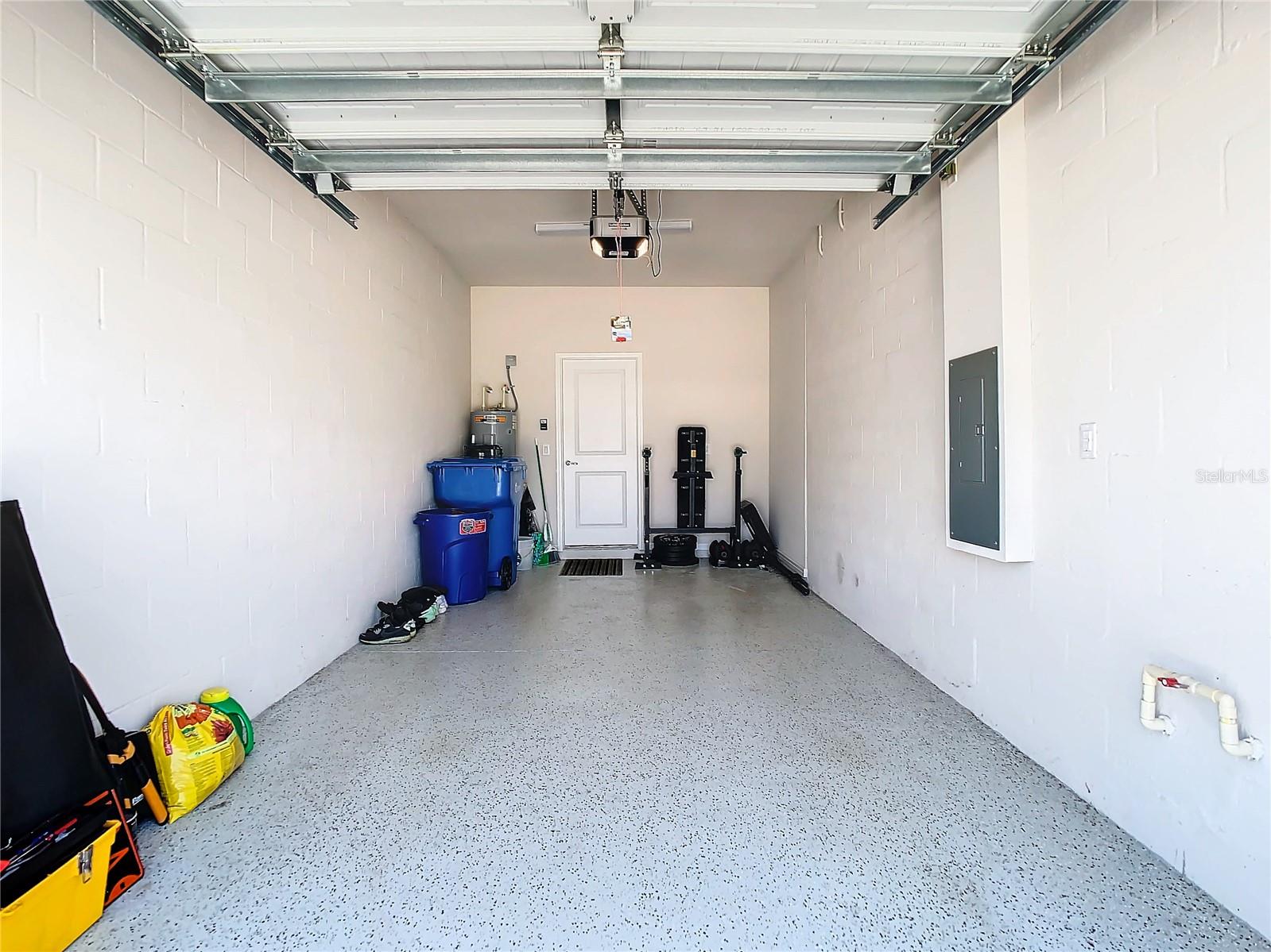 Attached garage with epoxy floor.