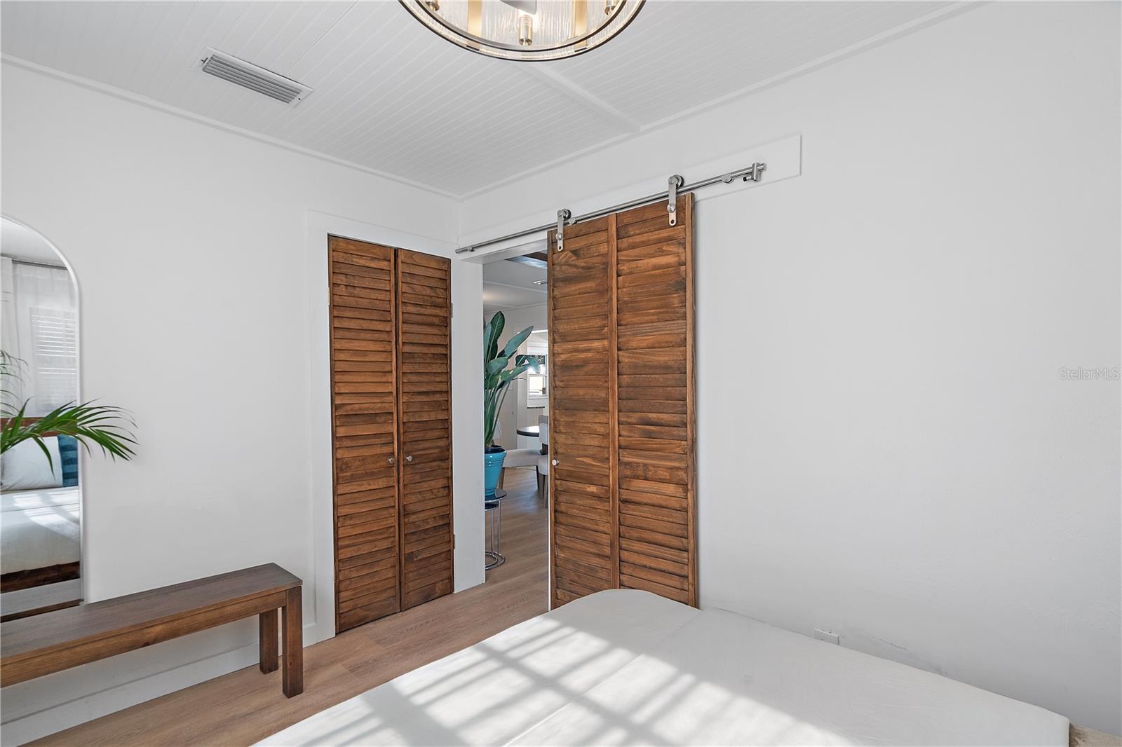 A wood shutter barn door adds privacy and character. The cedar closet is an elegant and practical addition, offering superior protection for stored items while adding a touch of natural beauty.