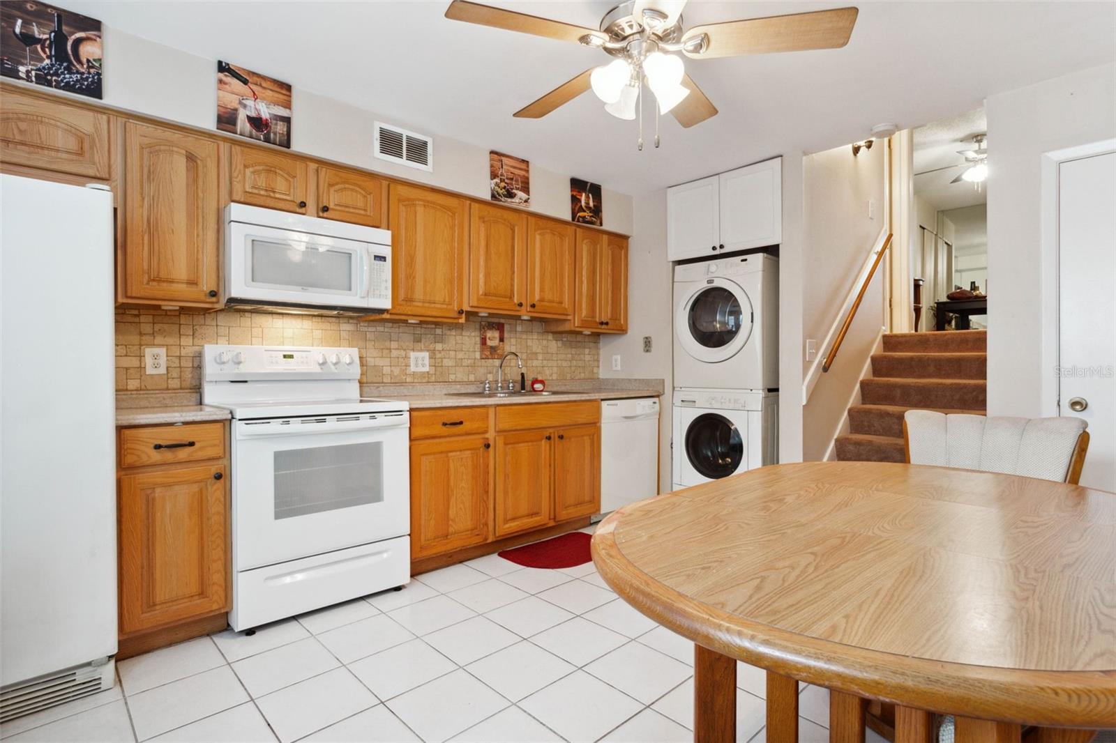 Eat in kitchen with stackable washer and dryer