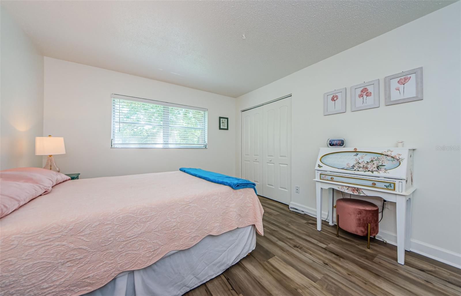 Master bedroom with luxury vinyl flooring with 5 inch baseboards