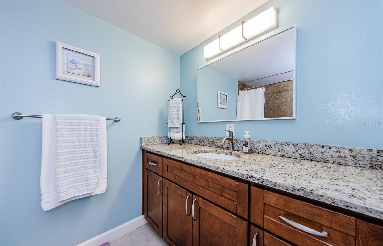 Beautiful, updated bathroom, granite countertop and has a linen closet