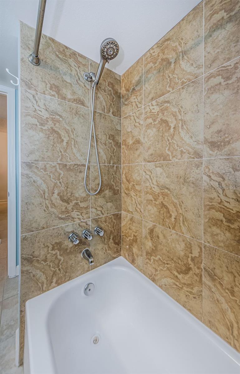 Travertine tile bath/shower commination