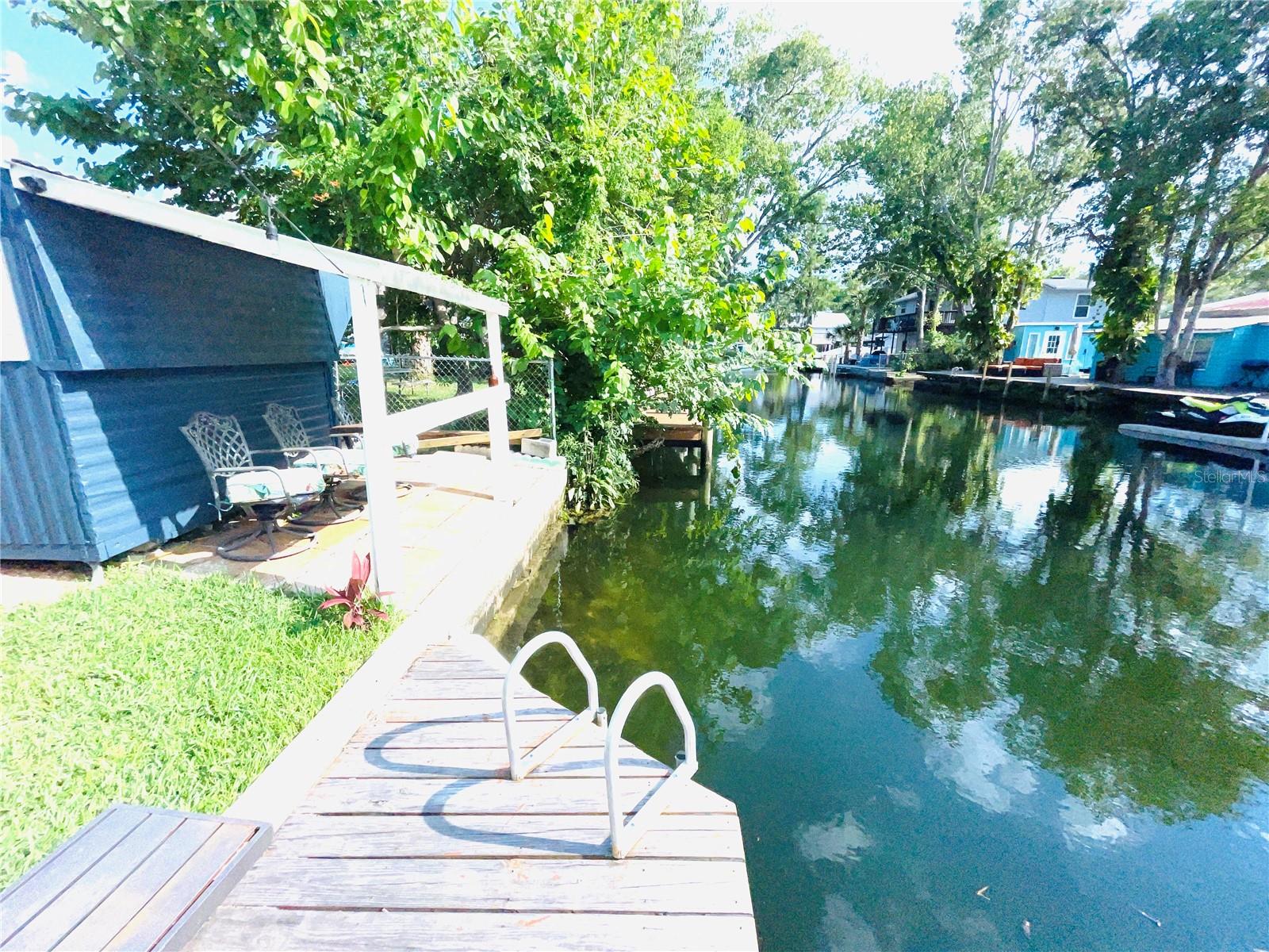 Backyard view with 2 Dual docks for easy water access and a ladder so you can swim, tube, float or kayak in your backyard then to the Spring, Hospital Hole, The Upper Deck Restaurant or the Gulf of Mexico