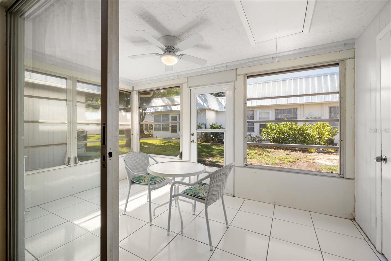 The enclosed lanai offers additional living space and storage. The lanai features a ceiling fan, windows, a storage closet as well as attic access.