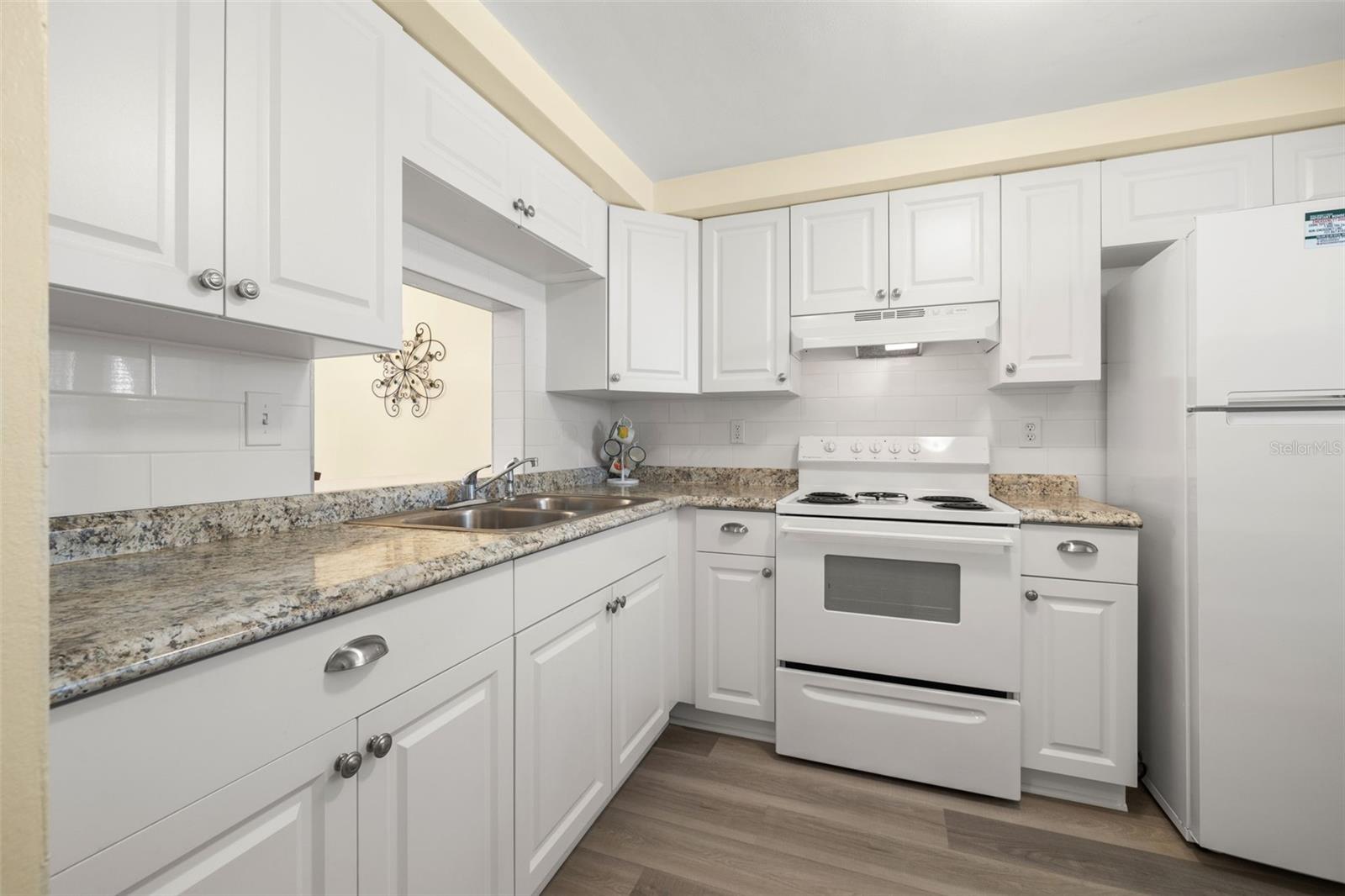 The kitchen has been updated with newer shaker style cabinets and matching appliances.