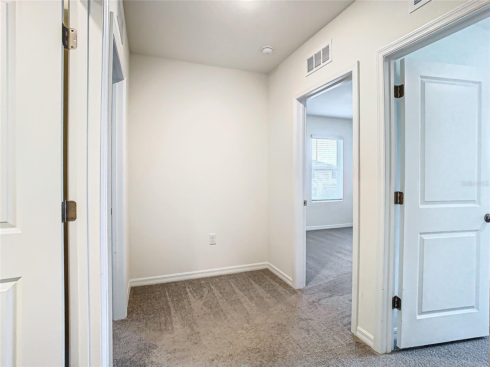 Hallway to Secondary bathroom and additional 3 bedrooms.