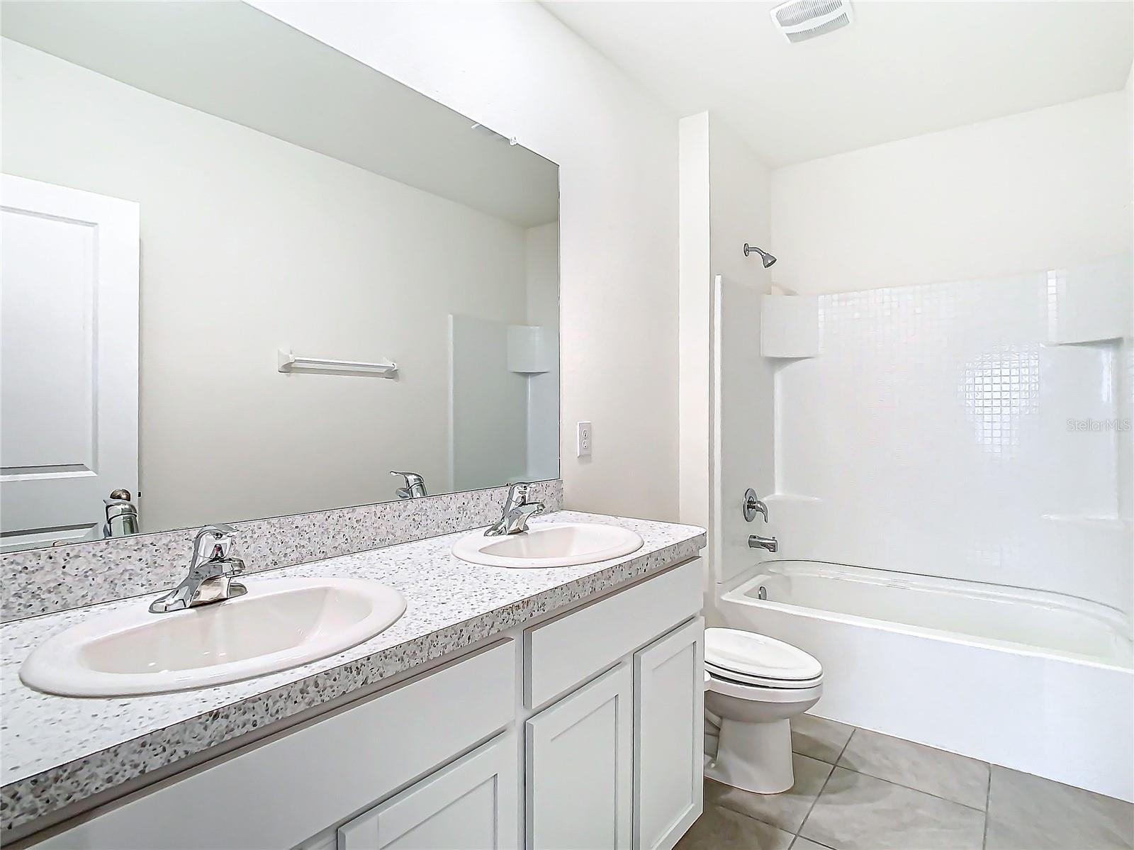 Hall bathroom on the second floor with bathtub shower combination.