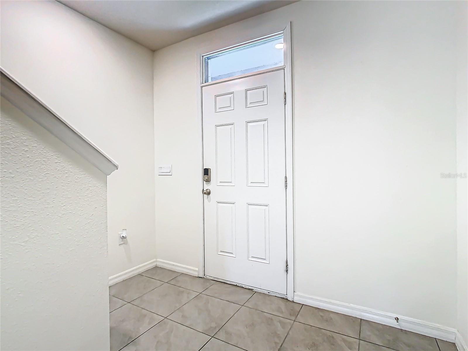 View of the front door from the hallway.