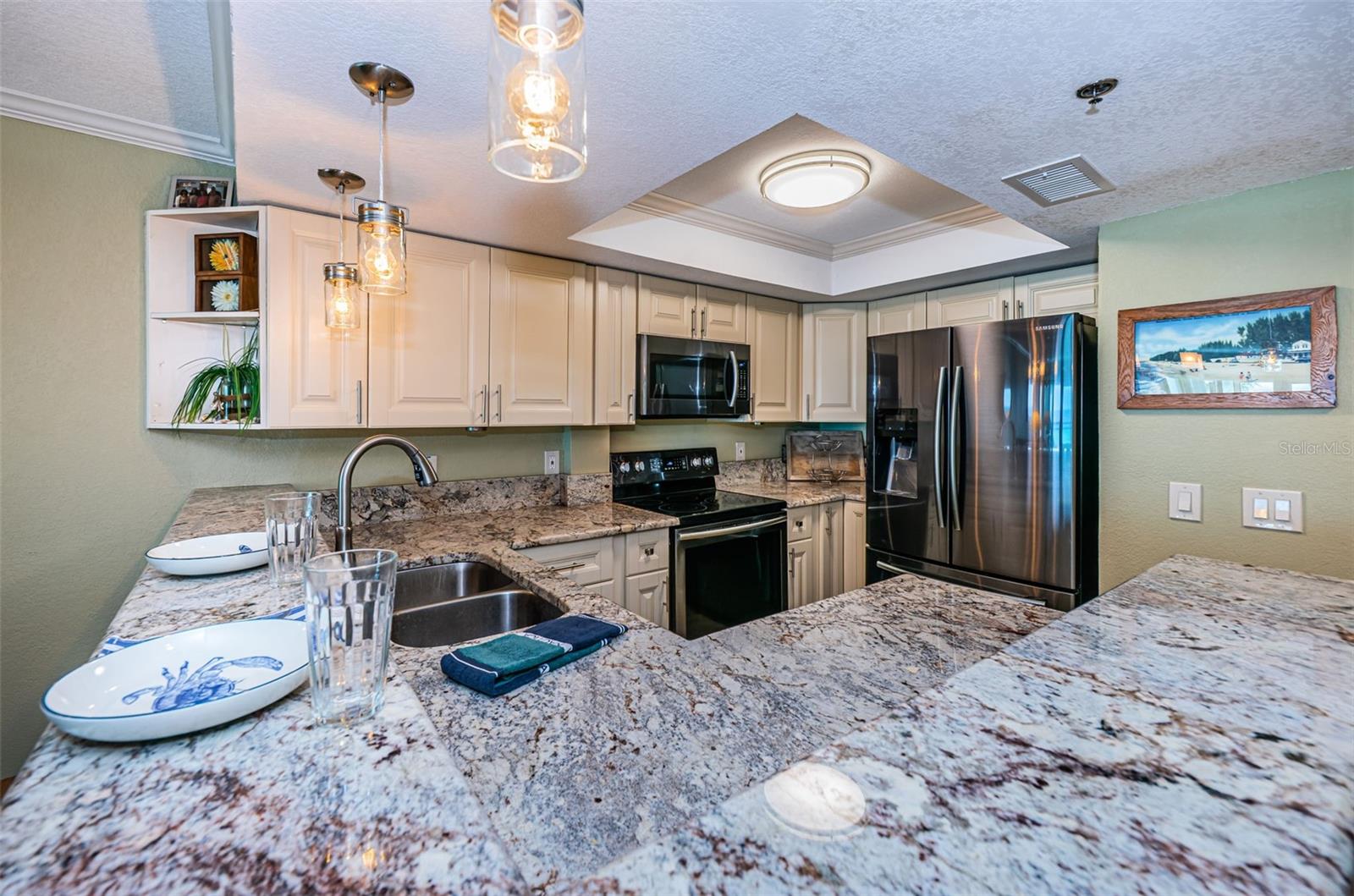 ... 13.2 x 11.5...  Kitchen with Step Up Breakfast Bar.. Looking In.. Stainless Steel Appliance Package Compliments Granite Color Choice... Recessed Ceiling Lights ...