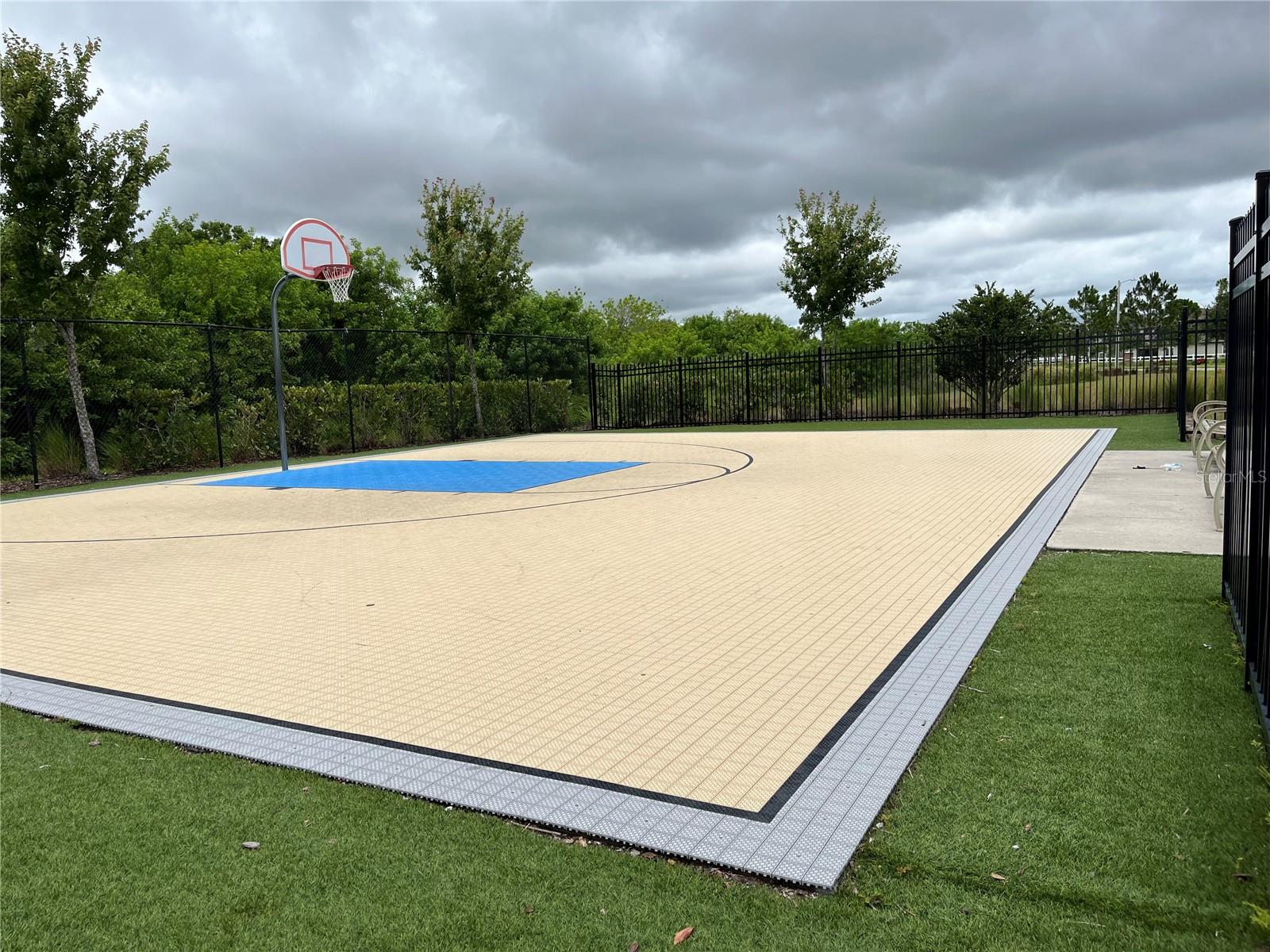 Basketball court near pool and playground, with nice seat benches