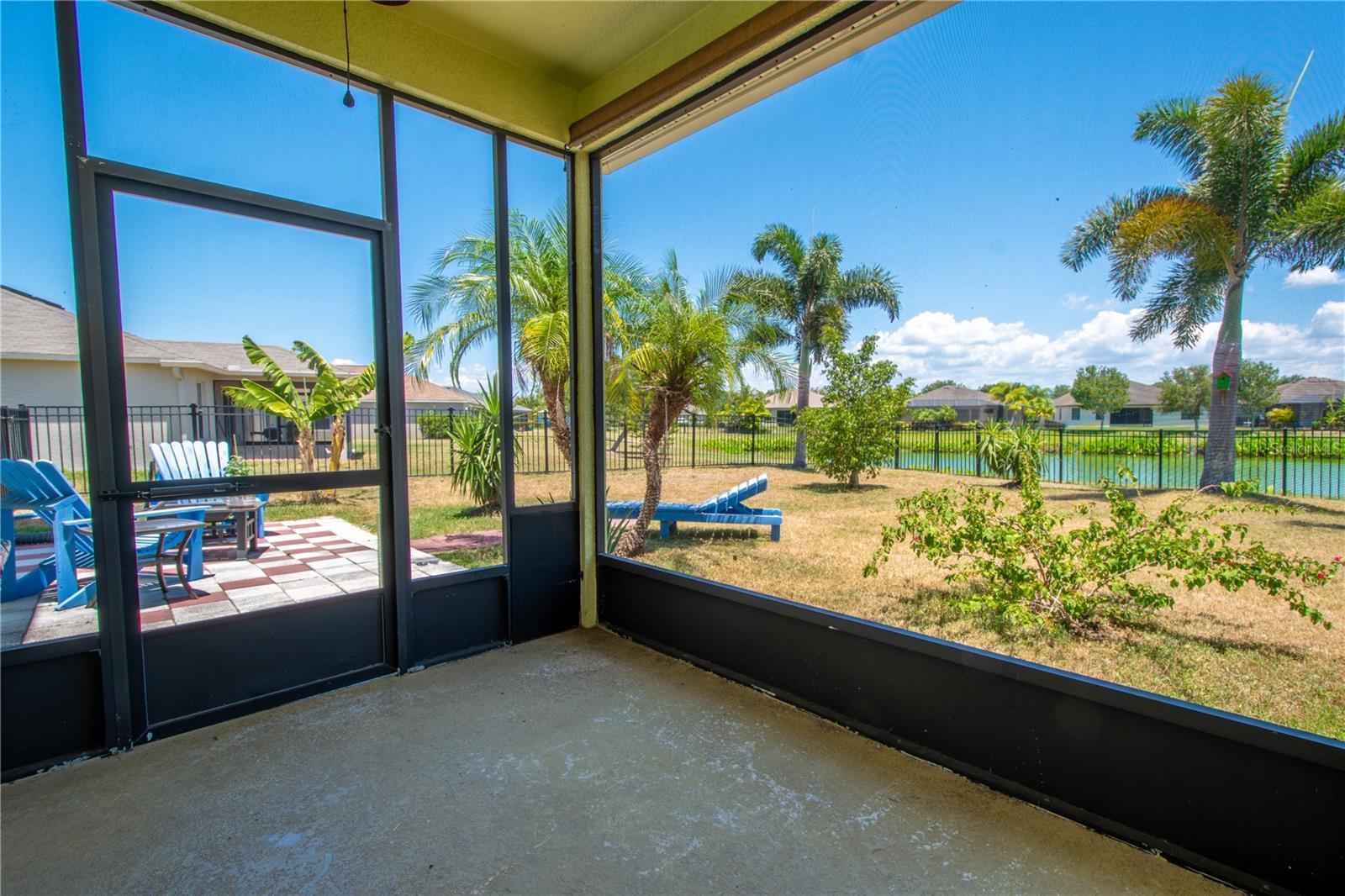 The screened in lanai features a serene lake view.