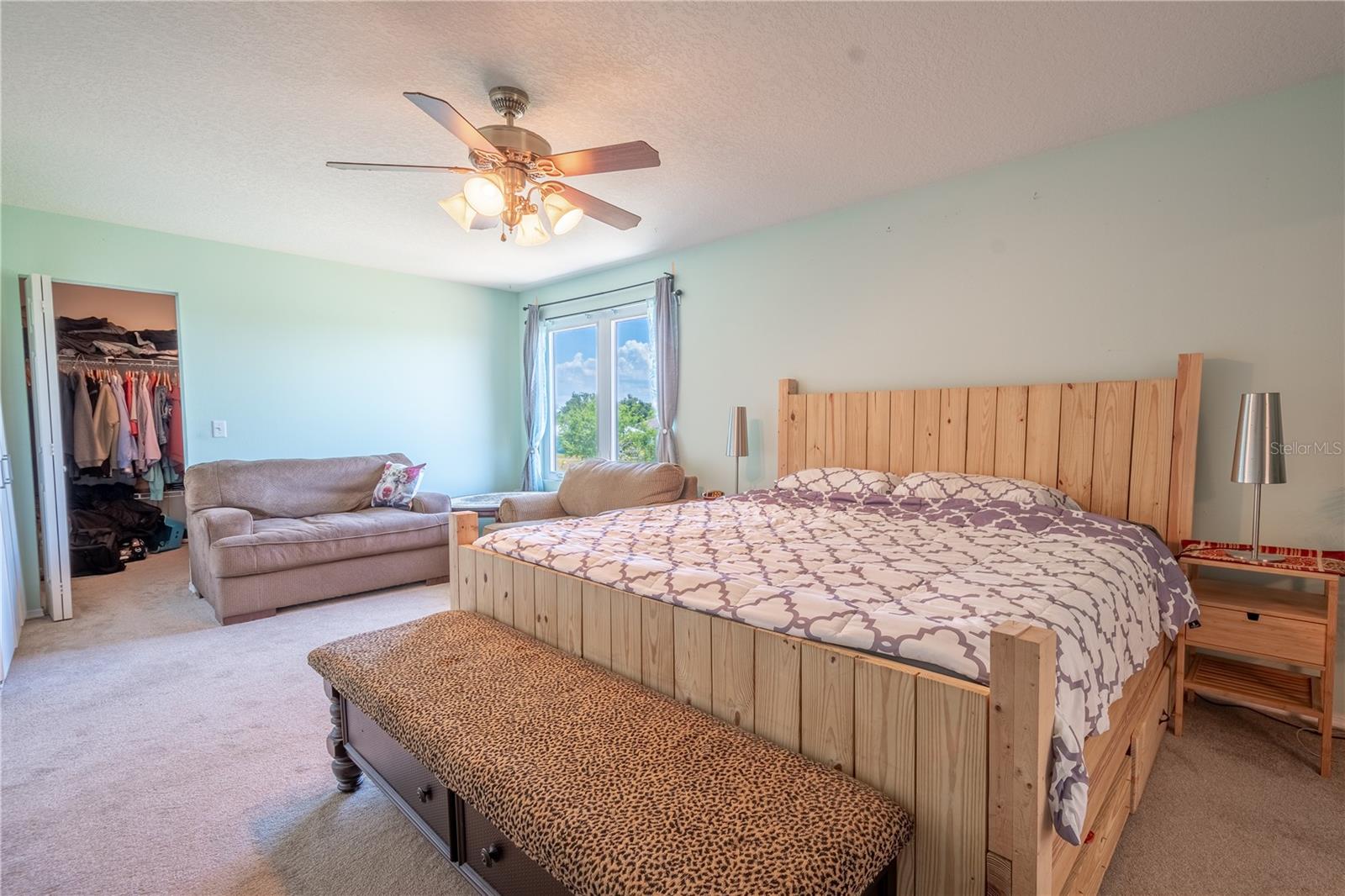 The primary bedroom is spacious enough to include all of your furniture, including a king-size bed.