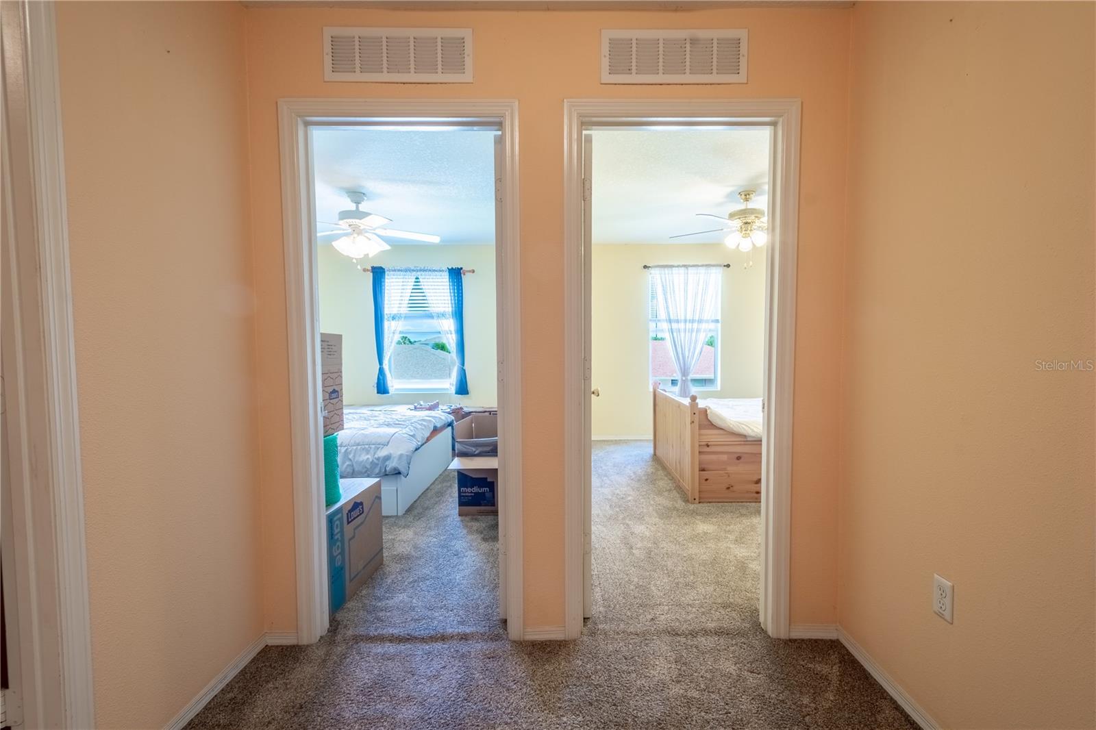 Bedroom's two and three feature plush neutral tone carpet and ceiling fans with light kits.