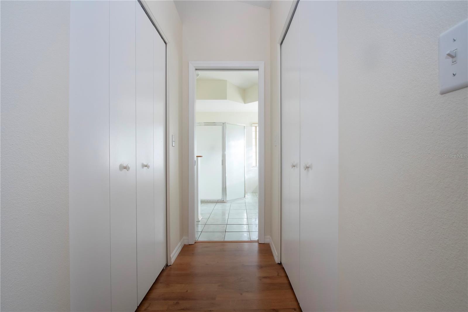 Walk-in closets flank the bathroom entrance