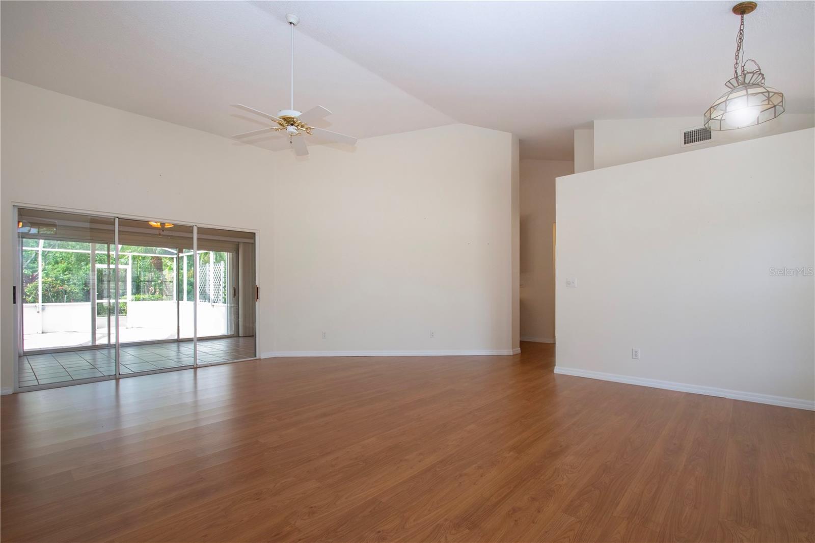 Soaring ceilings  and sliders to the enclosed  Florida room and lanai access