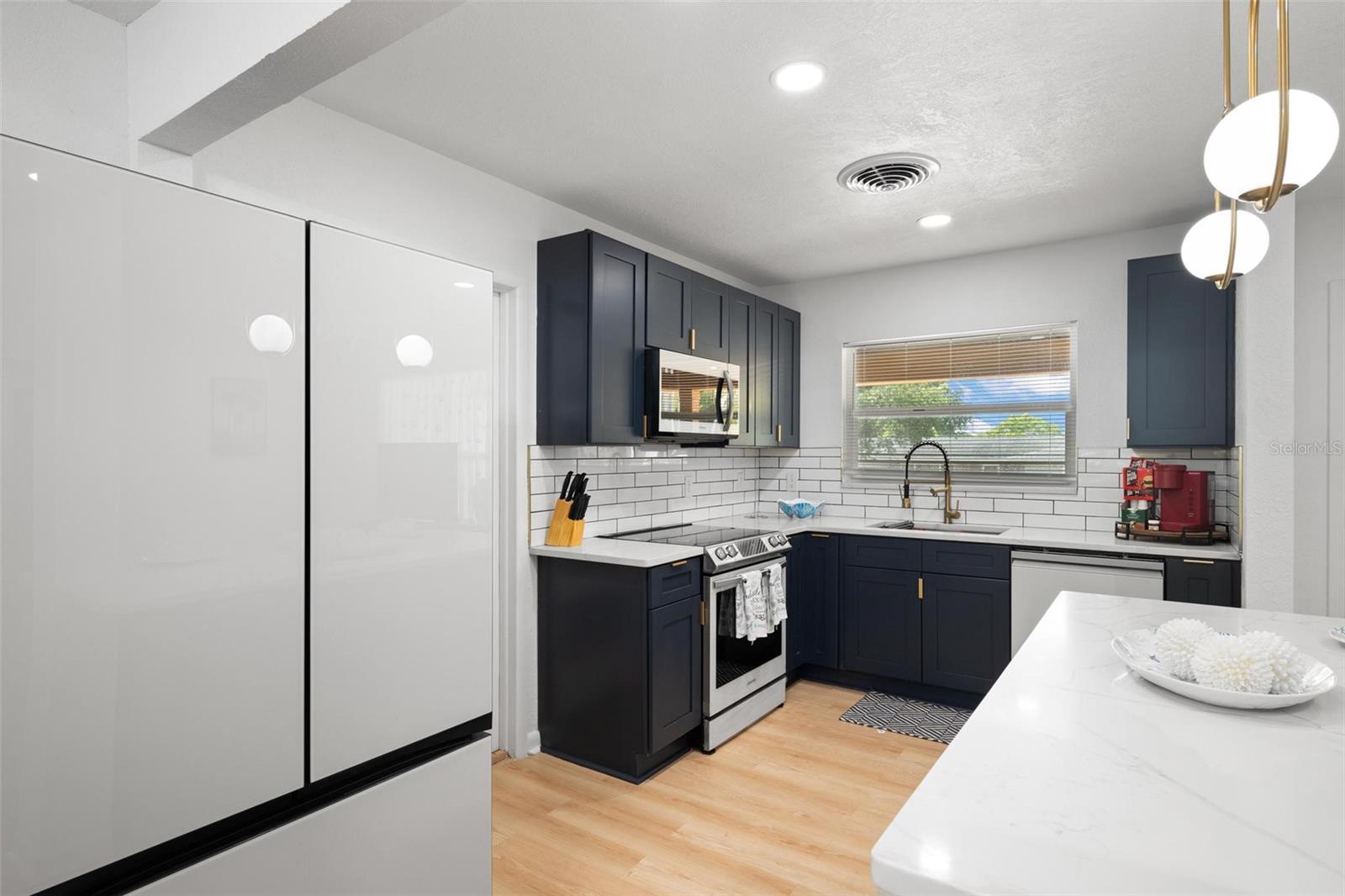 Beautifully renovated kitchen featuring Samsung "Bespoke" modern line of appliances