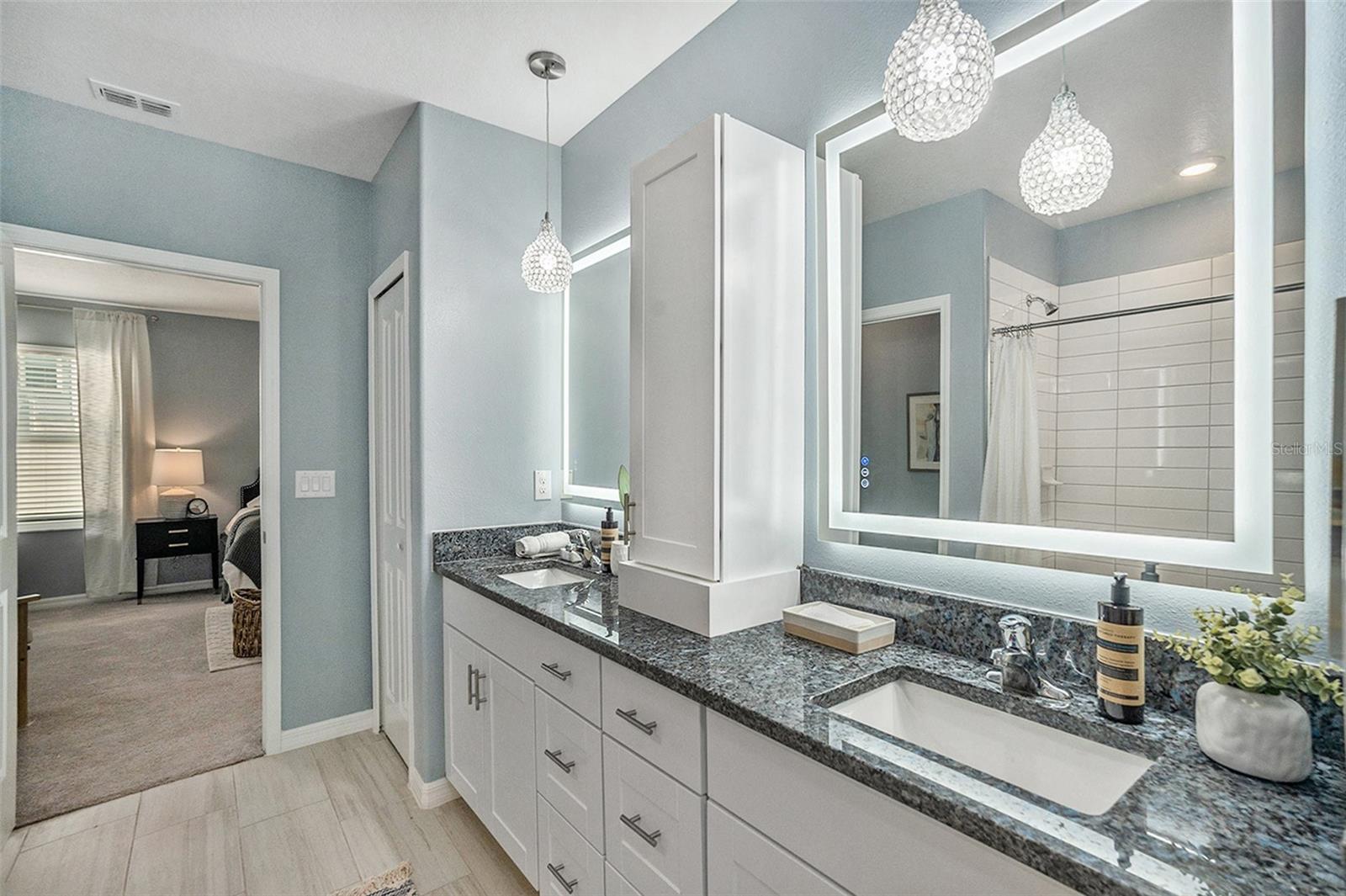 Owners Bathroom with custom cabinetry, lighting and mirrors